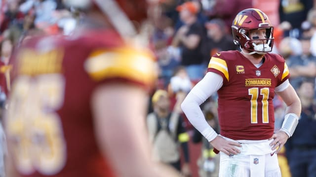Washington Commanders quarterback Carson Wentz (11) stands on the field after throwing an interception against the Cleveland Browns during the fourth quarter at FedExField.